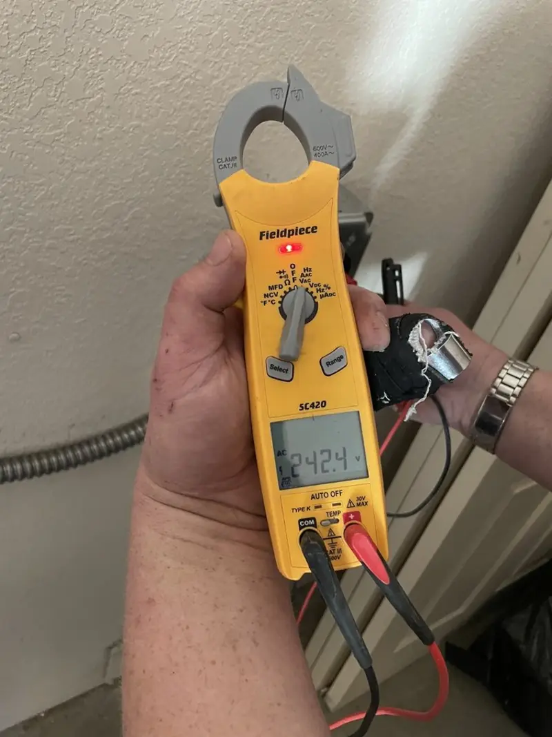 Voltage testing with clamp meter during Electrical Installation Services in McAllen